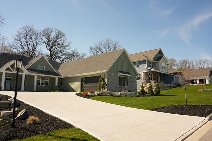 Finished landscaping and limestone boulder walls on a Waukesha County home