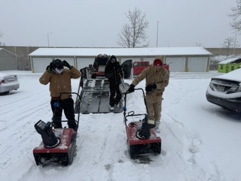 Loyal Landscaping crew clearing commercial walkways with snow blowers during a storm